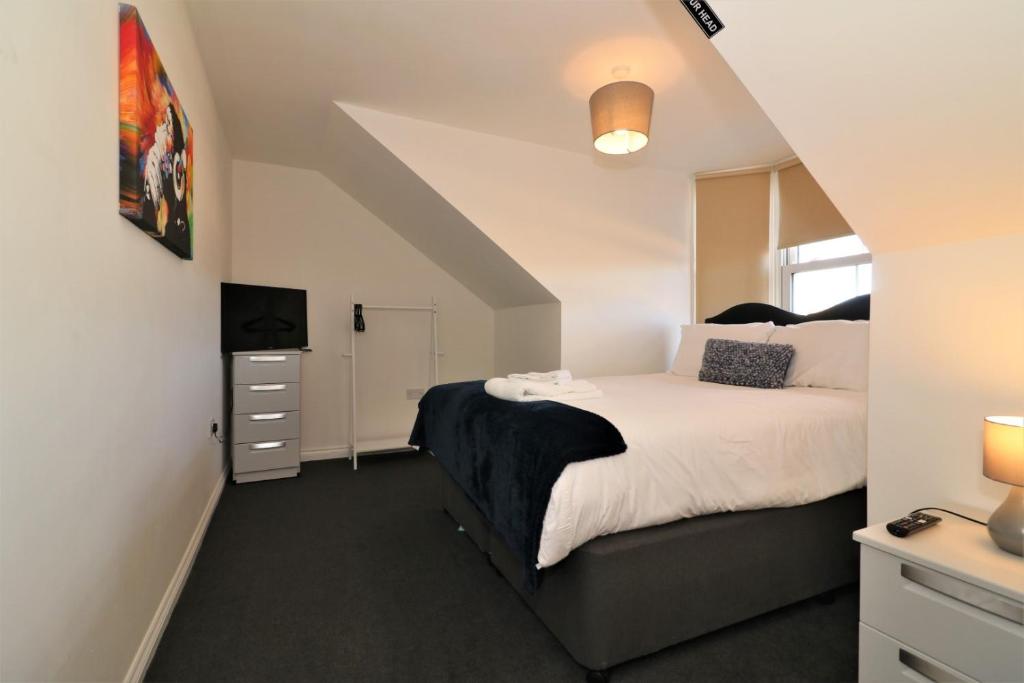 a bedroom with a bed and a television in it at Signature - No 11 Bonnet Apartments in Lanark