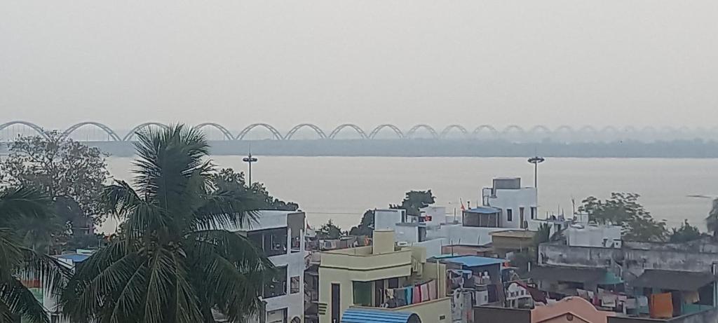 a view of a city with a bridge in the background at River view nectaar estates in Rājahmundry