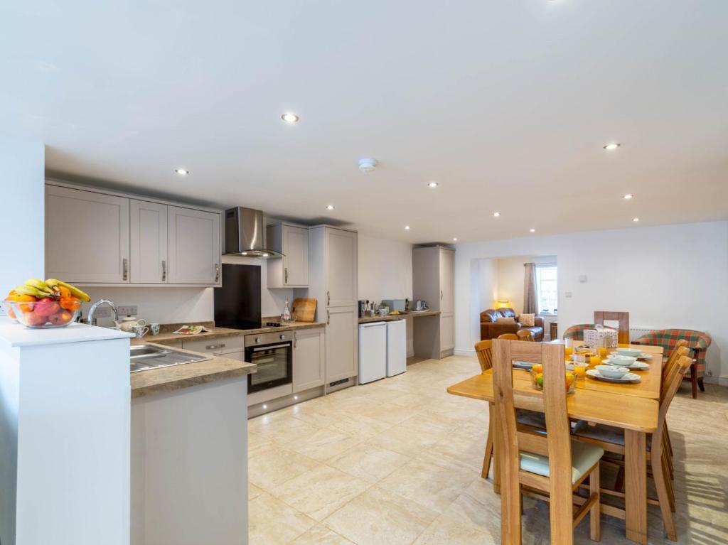 a kitchen and dining room with a table and chairs at 4 Bed in Langtoft 81235 in Weaverthorpe