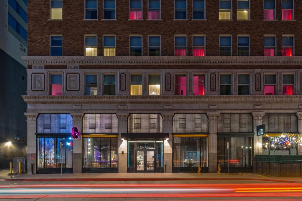 a building on the corner of a street at night at Moxy Phoenix Downtown in Phoenix