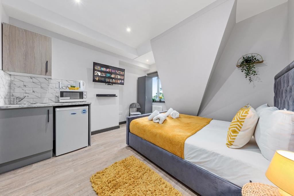 um quarto com uma cama grande e uma cozinha em Captivating Serviced Room Sydenham London SE26 em Londres