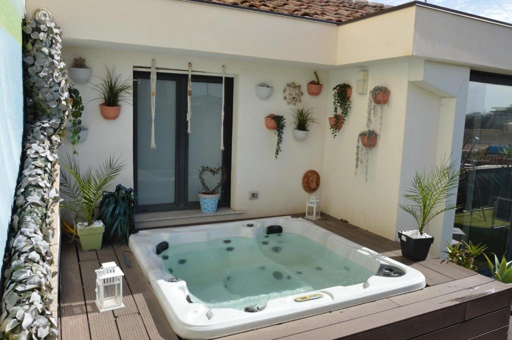 a hot tub on the deck of a house at b&b le 4 leggende in Catania