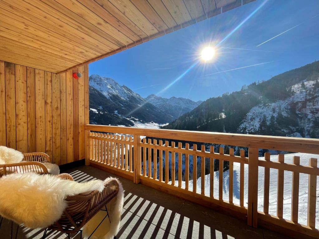 a room with a balcony with a view of the mountains at Bio-Bauernhof Hirschleiten in Kleinarl