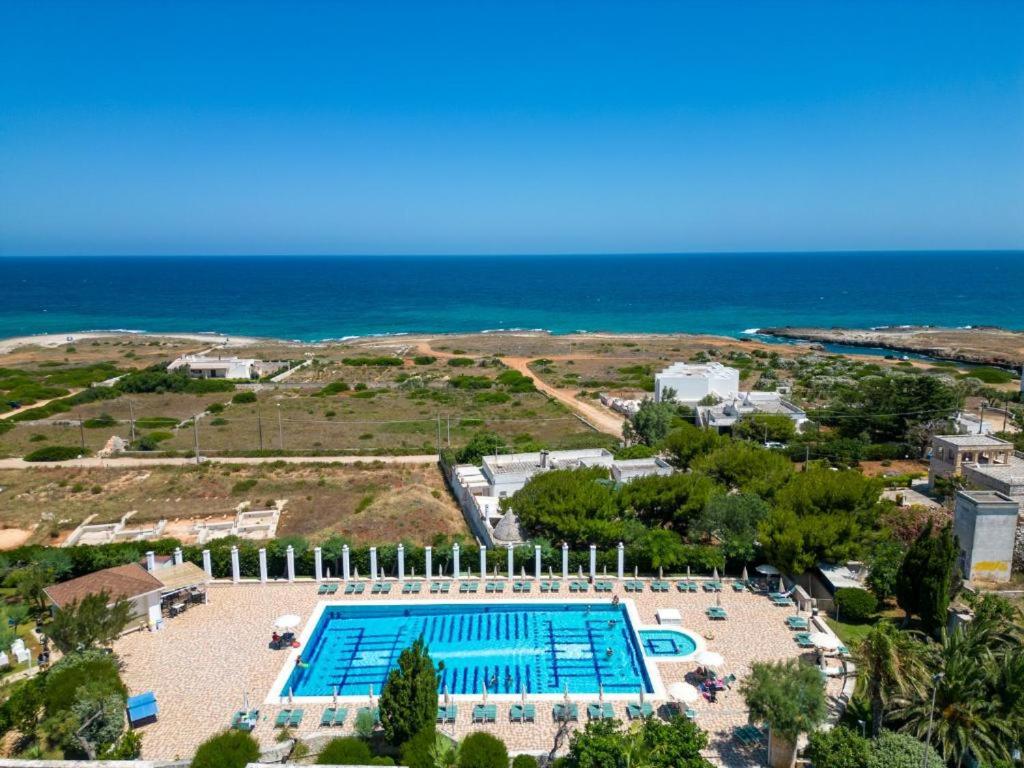 an aerial view of a swimming pool next to the ocean at Hotel Scoglio Degli Achei in Torre Santa Sabina