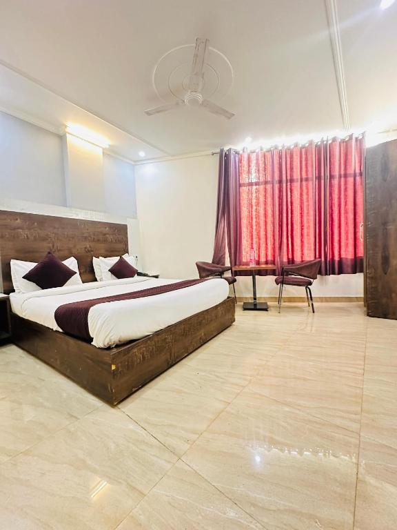 a bedroom with a large bed and a window at Hotel S R Palace Delhi Airport Unit BY URBAN Luxury in New Delhi