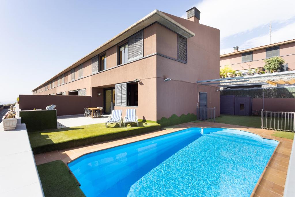 a swimming pool in front of a house at Home2Book Charming House Private Pool & Terrace in Santa Cruz de Tenerife