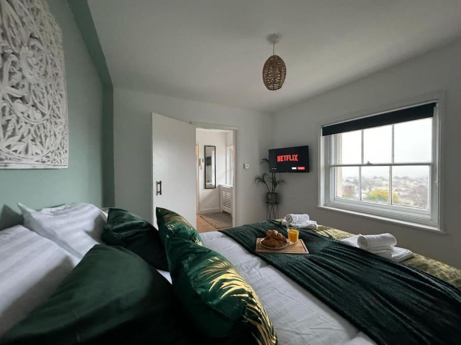 a bedroom with a large bed with avertisementatronatronstrationstrationstration at Sea View 2 Bed Apartment No 6 in Ryde