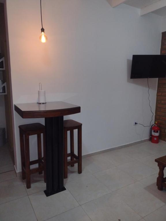 a table and stool with a candle on top of it at San Juan Apart in Santa Lucía