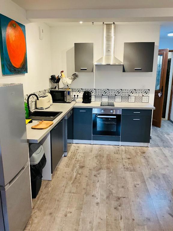 a kitchen with blue and white counters and appliances at No 25 superbe apartment plein centre calme ,Netflix in Mirepoix