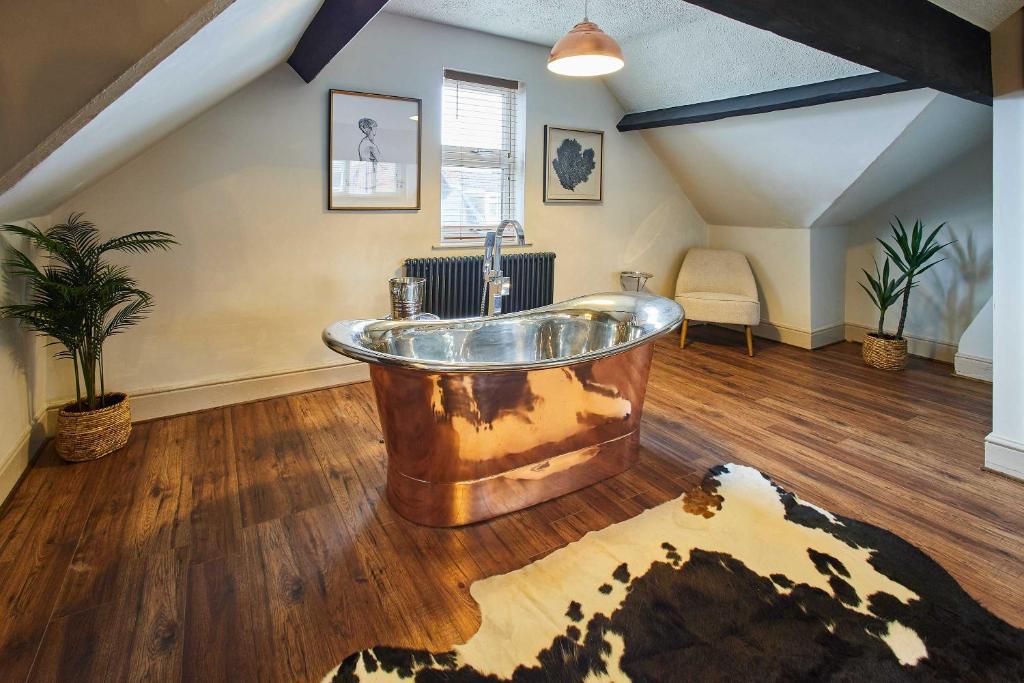 a large bathroom with a copper tub in a attic at Host & Stay - Emerald Beach House in Saltburn-by-the-Sea