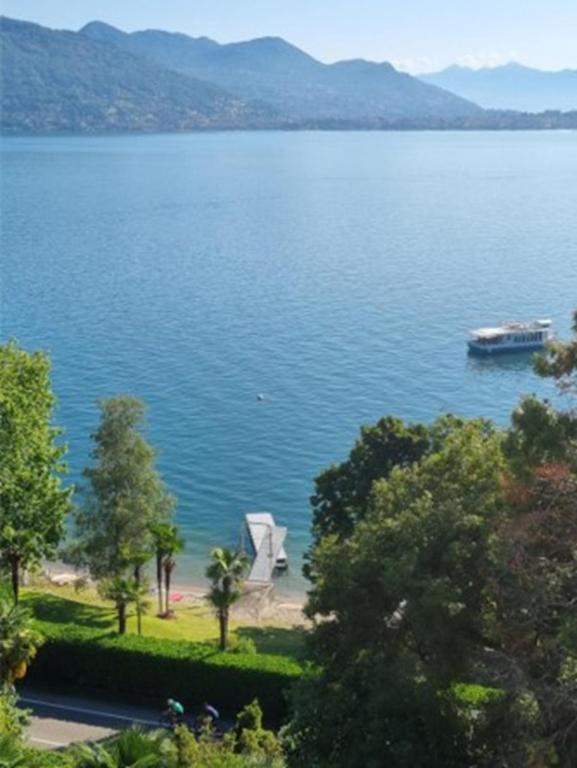 a view of a large lake with a boat in it at Apartment camelie with private beach in Baveno