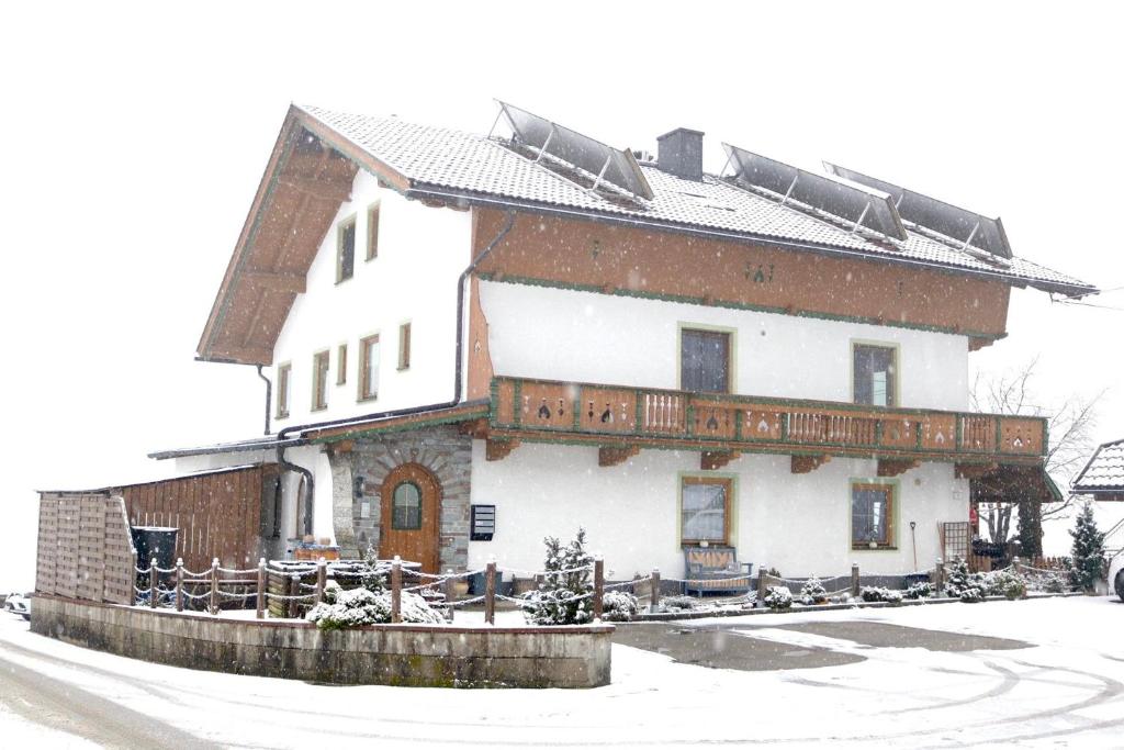 a large house with snow on the roof at Appartement Natalie in Ried im Zillertal