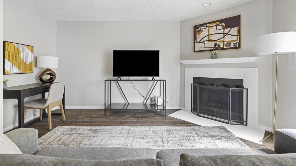 a living room with a fireplace and a flat screen tv at Landing Modern Apartment with Amazing Amenities (ID1274X054) in Vancouver