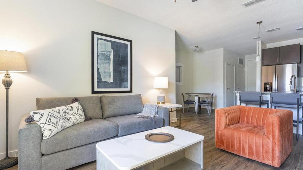 a living room with a couch and a chair at Landing Modern Apartment with Amazing Amenities (ID4496) in Jacksonville