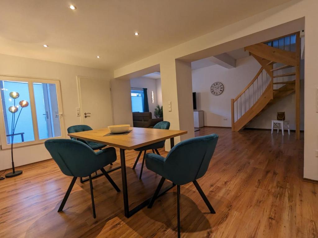 Un comedor con mesa y sillas de madera. en Ferienwohnung Selma, en Wilhelmshaven