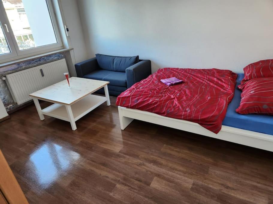 a room with a bed and a couch and a table at 2: Einfache 1-Zimmer Wohnung in Bad Wörishofen in Bad Wörishofen