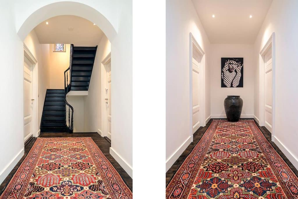 a hallway with a rug on the floor and a hallway with a staircase at Bohemian Residence in Maastricht