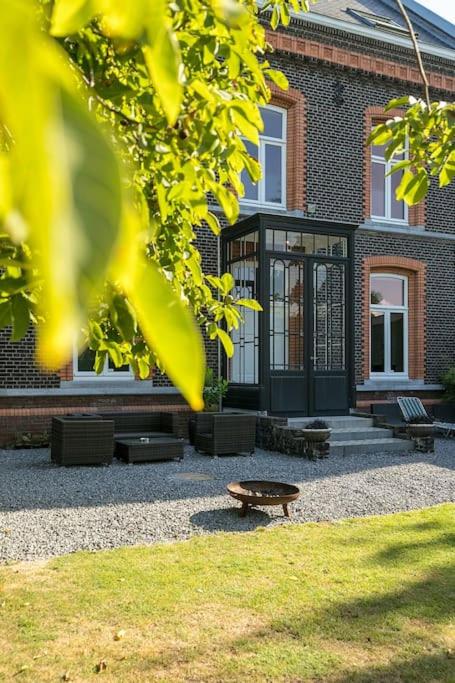 a building with a bench and a table in front of it at Bohemian Residence in Maastricht