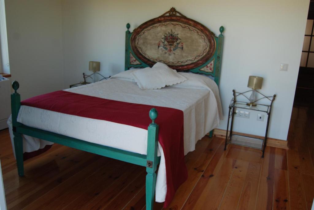 Casa De Besteiros في Arneiro da Volta: غرفة نوم بسرير ذو اطار اخضر