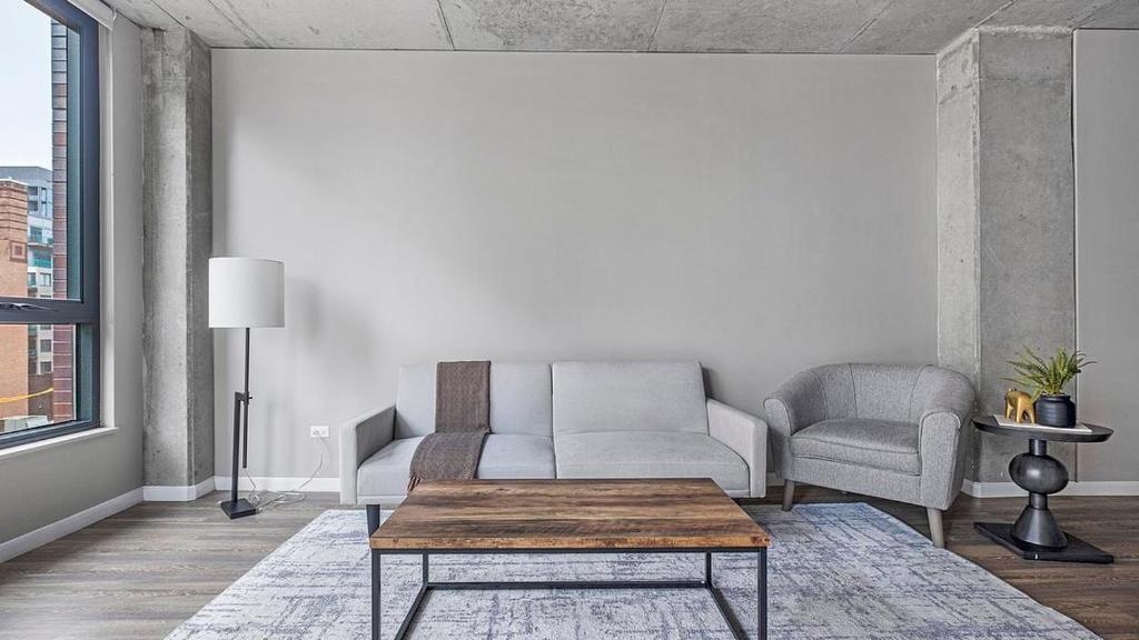 a living room with a couch and a table at Landing Modern Apartment with Amazing Amenities (ID4859X97) in Chicago