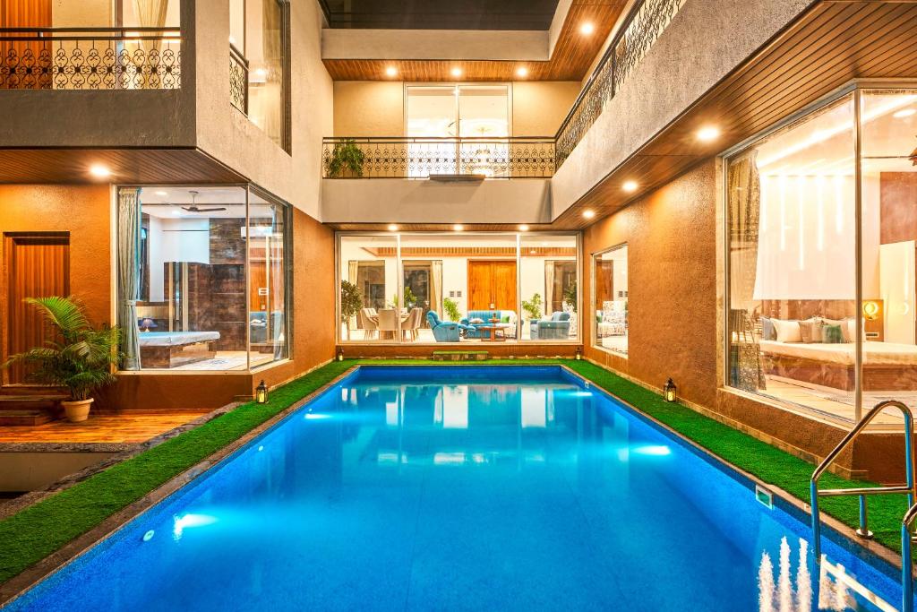 an indoor swimming pool in a house with a house at EKOSTAY - Luxe - La Casa Grande in Lonavala