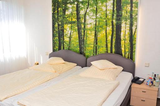 Postel nebo postele na pokoji v ubytování Hotel Bertram