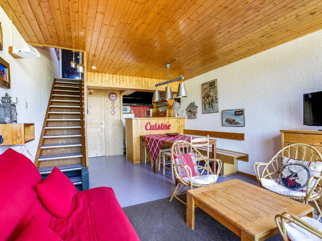 a living room with a red couch and a table at Appartement Les Arcs 1600, 2 pièces, 7 personnes - FR-1-411-504 in Arc 1600