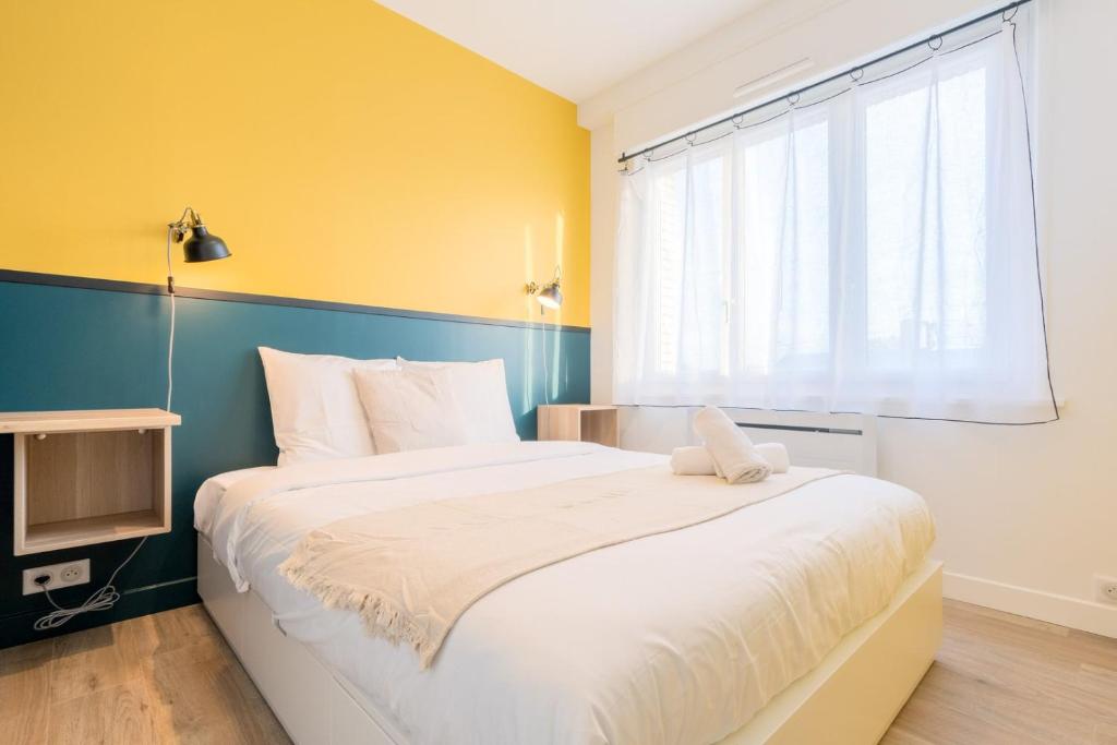 a bedroom with a large bed and a window at Marcq-en-Baroeul - Beautiful apartment Art-déco ! in Marquette-lès-Lille