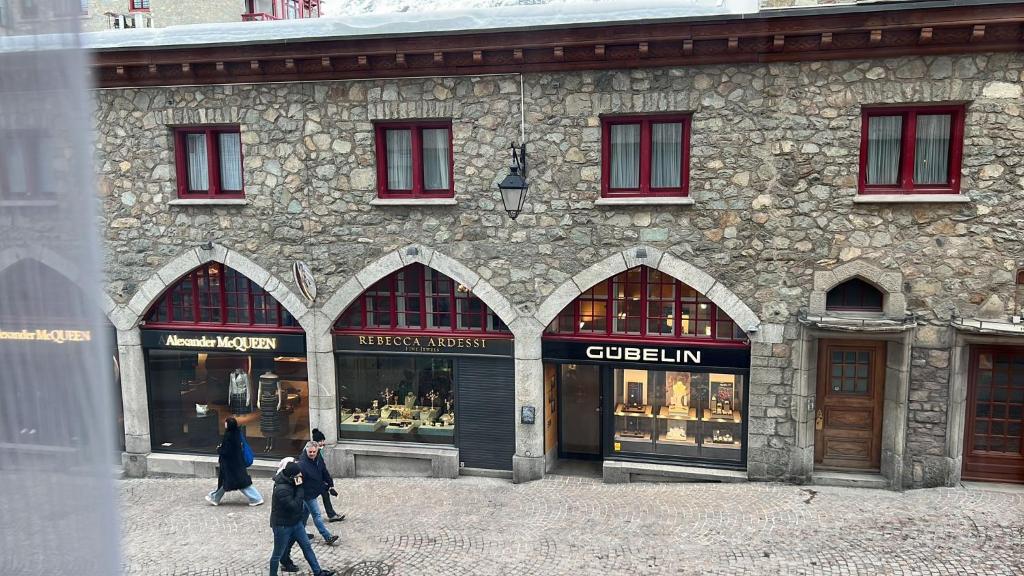 a group of people walking in front of a building at Little studio in the center in St. Moritz