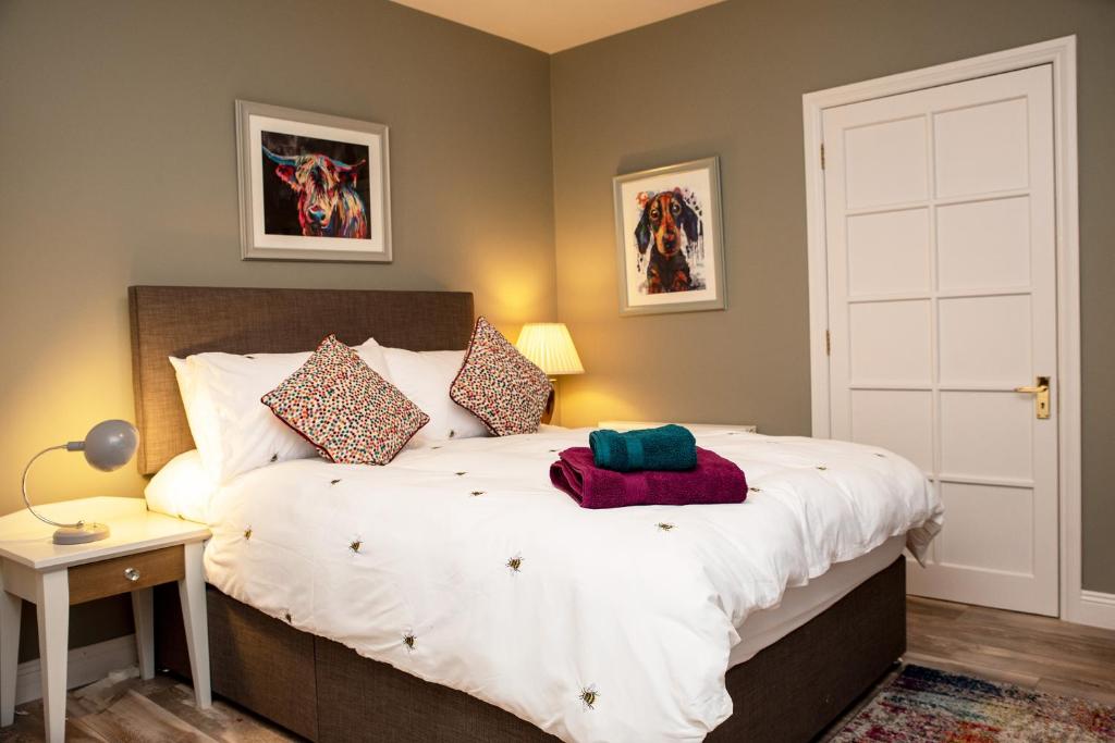 a bedroom with a large white bed in a room at The Veterinary @ Kildare Village in Kildare