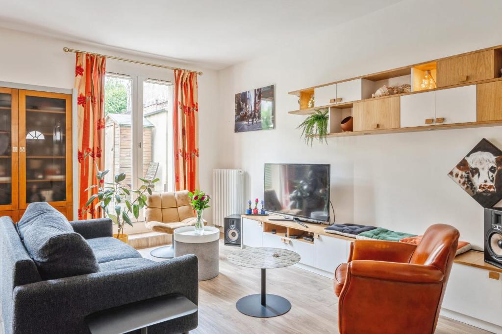 un salon avec un canapé et une table dans l'établissement Maison Ventana - Welkeys, à Versailles