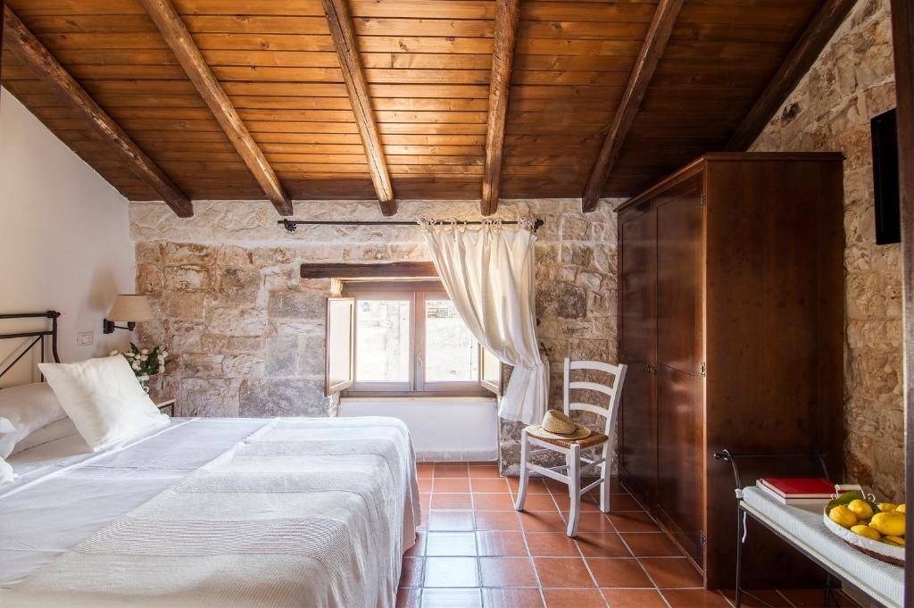 Postel nebo postele na pokoji v ubytování Hotel Corte Altavilla