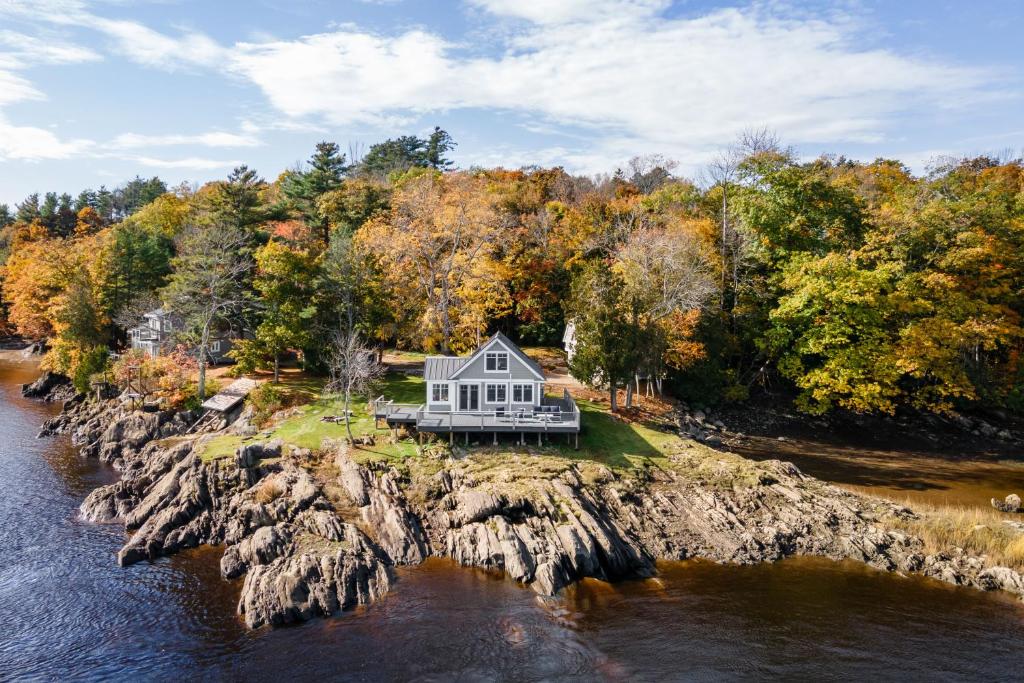 a house on an island in the water at Cozy Cottage on the Penobscot — Panoramic Luxury! 