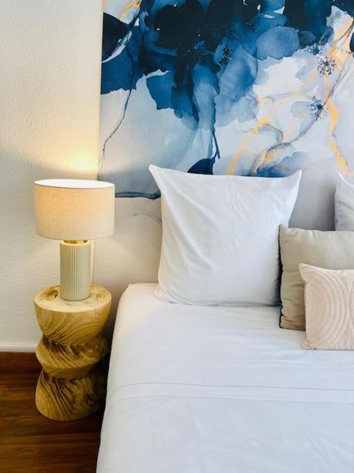 - une chambre avec un lit et une lampe à côté dans l'établissement ''Chichi 2'' Chez Paule Superbe appartement en plein coeur de Sète, à Sète