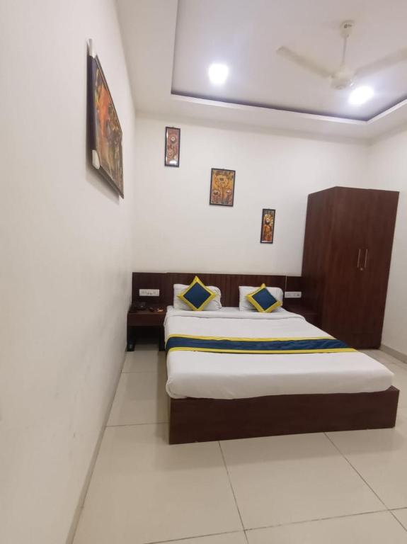 Postel nebo postele na pokoji v ubytování Hotel Lakshya Sheesh Mahal Indore