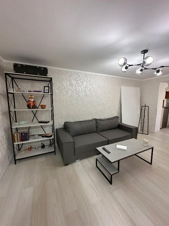 a living room with a couch and a coffee table at Fresh and cozy apartmrent in Yakkasaray