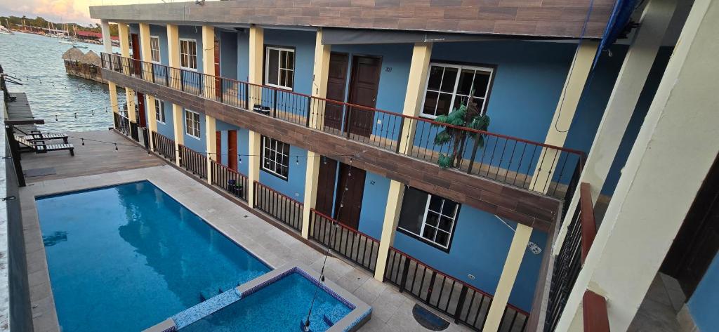 a house with a swimming pool on a balcony at Hotel Real del Rio in Rio Dulce