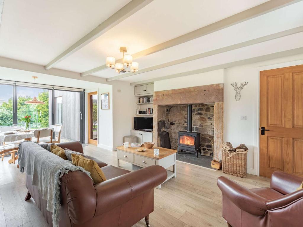 a living room with a couch and a fireplace at 3 Bed in Northumberland National Park CN039 in Alwinton