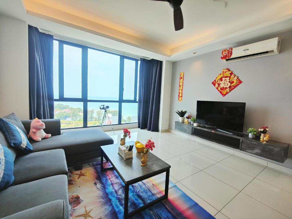 a living room with a couch and a tv at Amazing Seaview 2 Bedroom Bathtub Georgetown 6-8people超级海景双房带浴缸高级公寓 in George Town