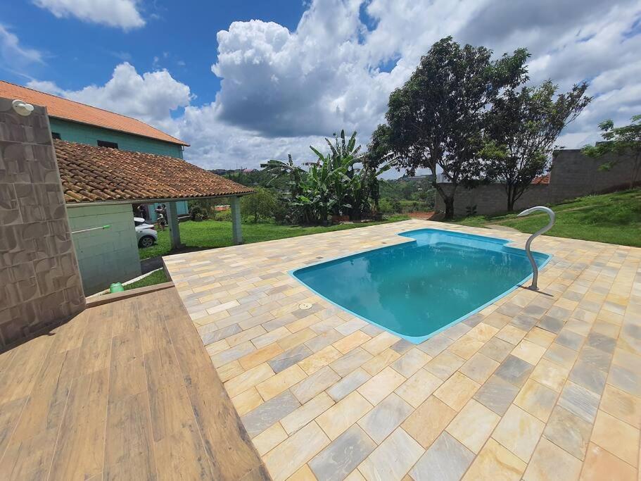 uma piscina no quintal de uma casa em Chácara ( Dona Juju) super confortável em Igarata/SP! em Igaratá