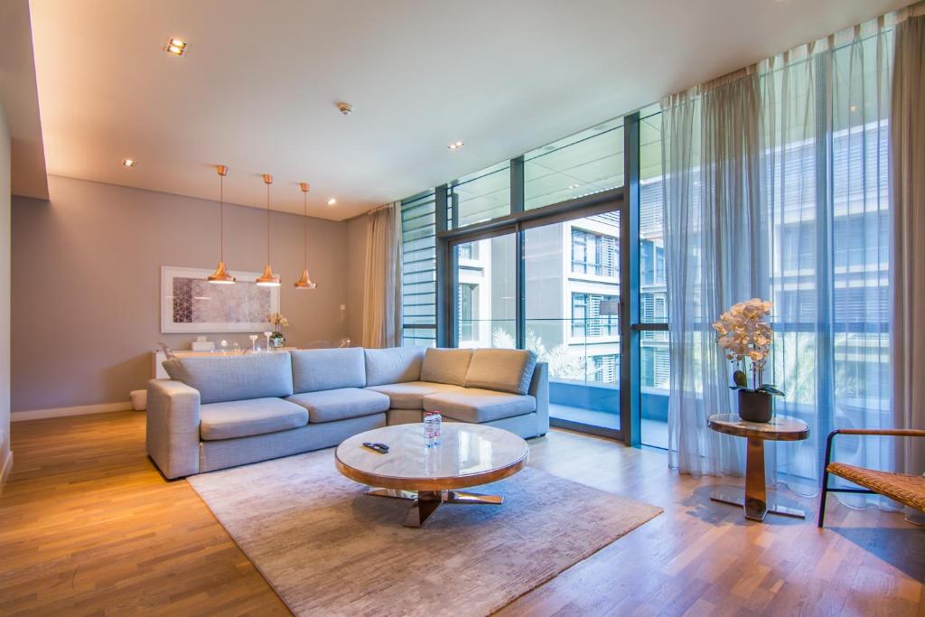 a living room with a couch and a table at Cityscape lofts Living in City Walk 2BR Unit in Dubai