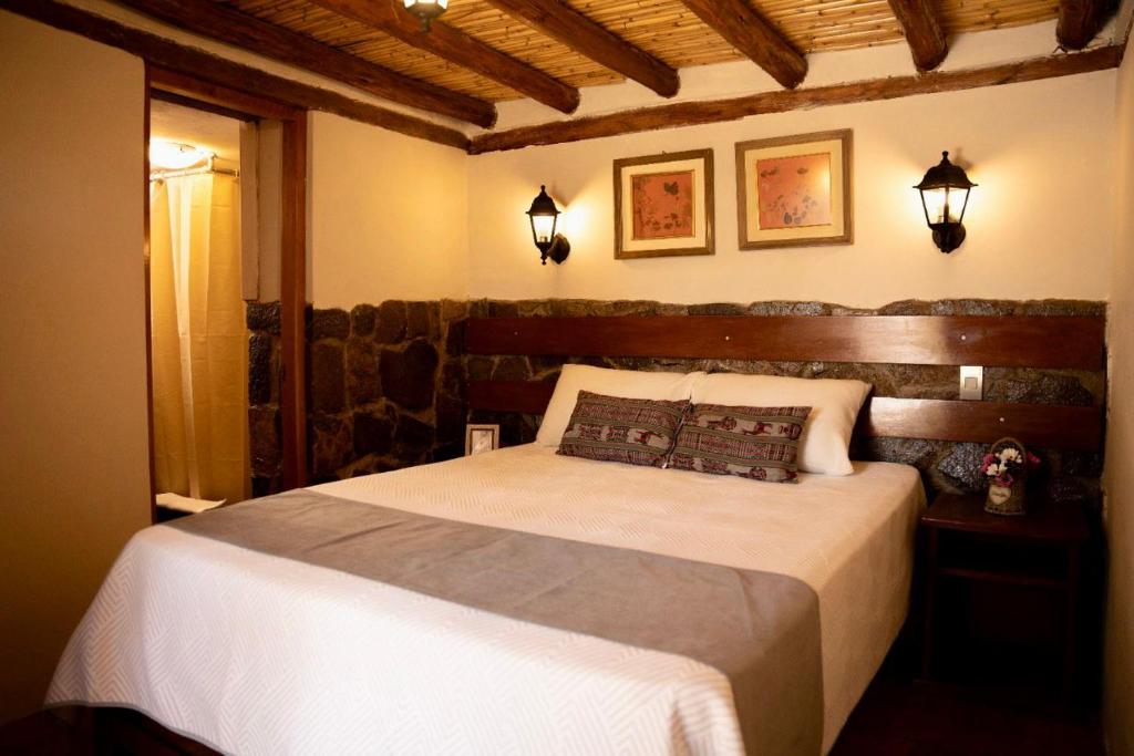 Postel nebo postele na pokoji v ubytování Lodge El Portal de Qopuy