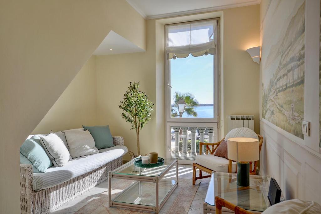 a living room with a couch and a table at Gramsci 79 - Beachfront in Santa Margherita Ligure
