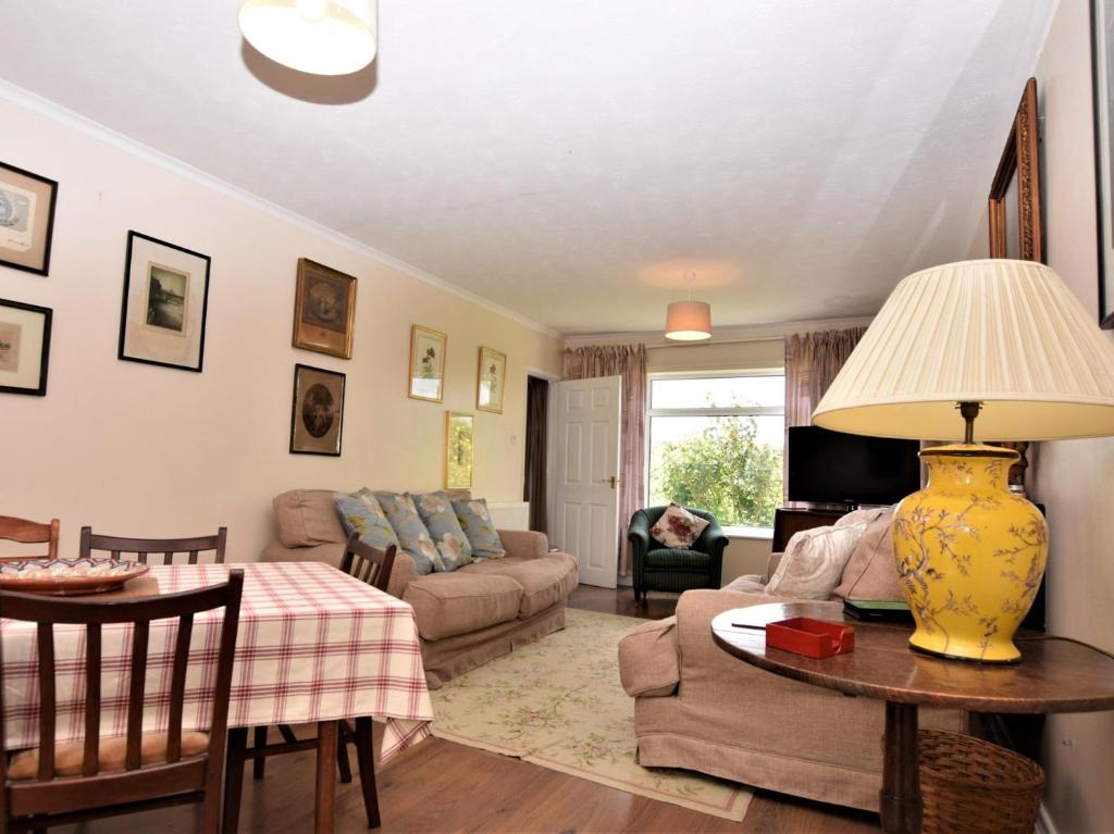 a living room with a couch and a table at 3 Bed in Great Snoring KT075 in Great Snoring