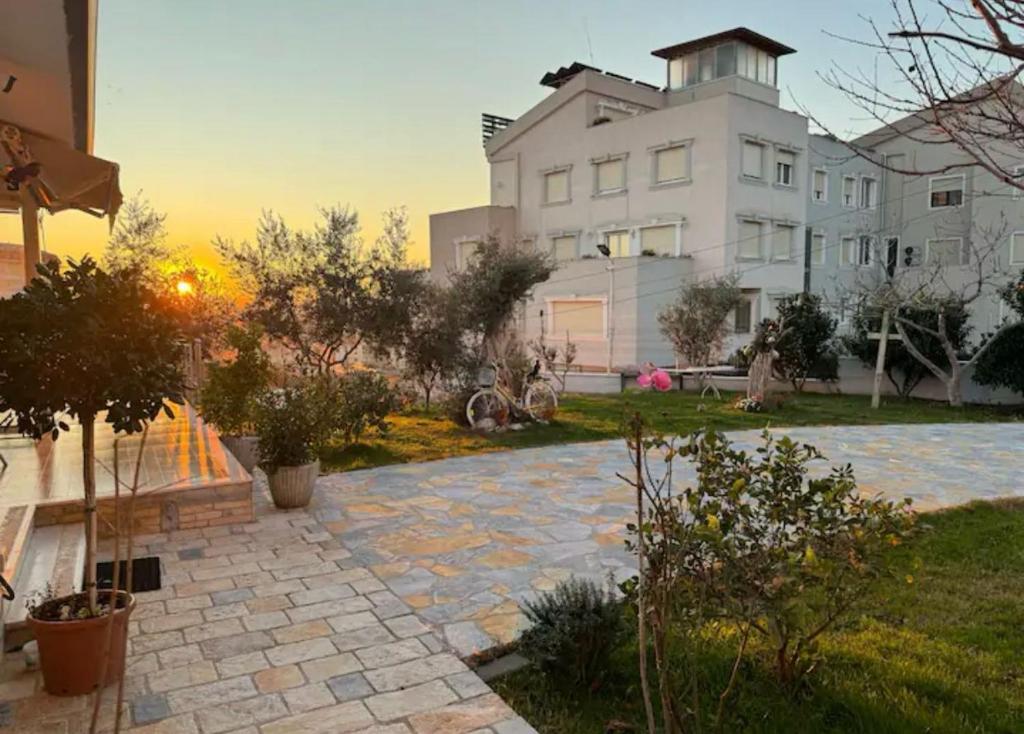 a house with a stone walkway in front of a building at Villa Nikol in Tirana