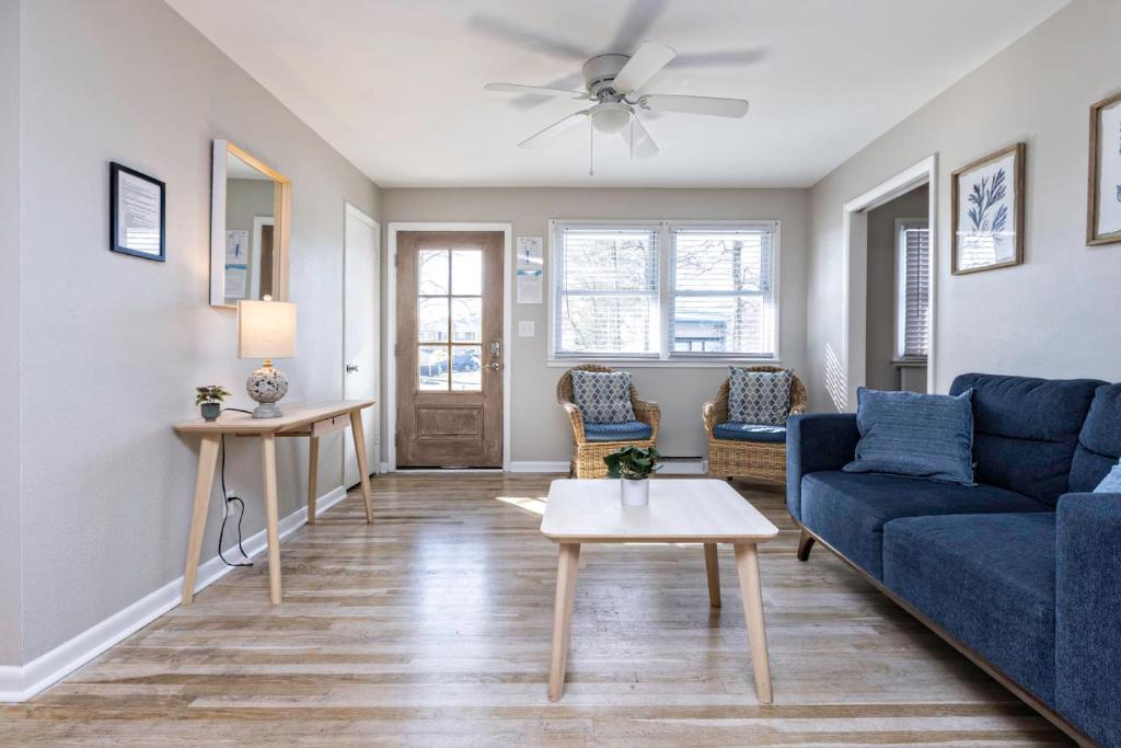a living room with a blue couch and a table at Rejuvenation and Relaxation in Virginia Beach