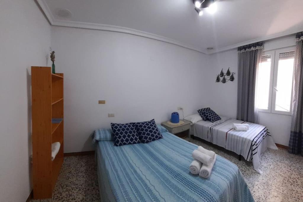 a bedroom with two beds with towels on them at can tica in Bocairent
