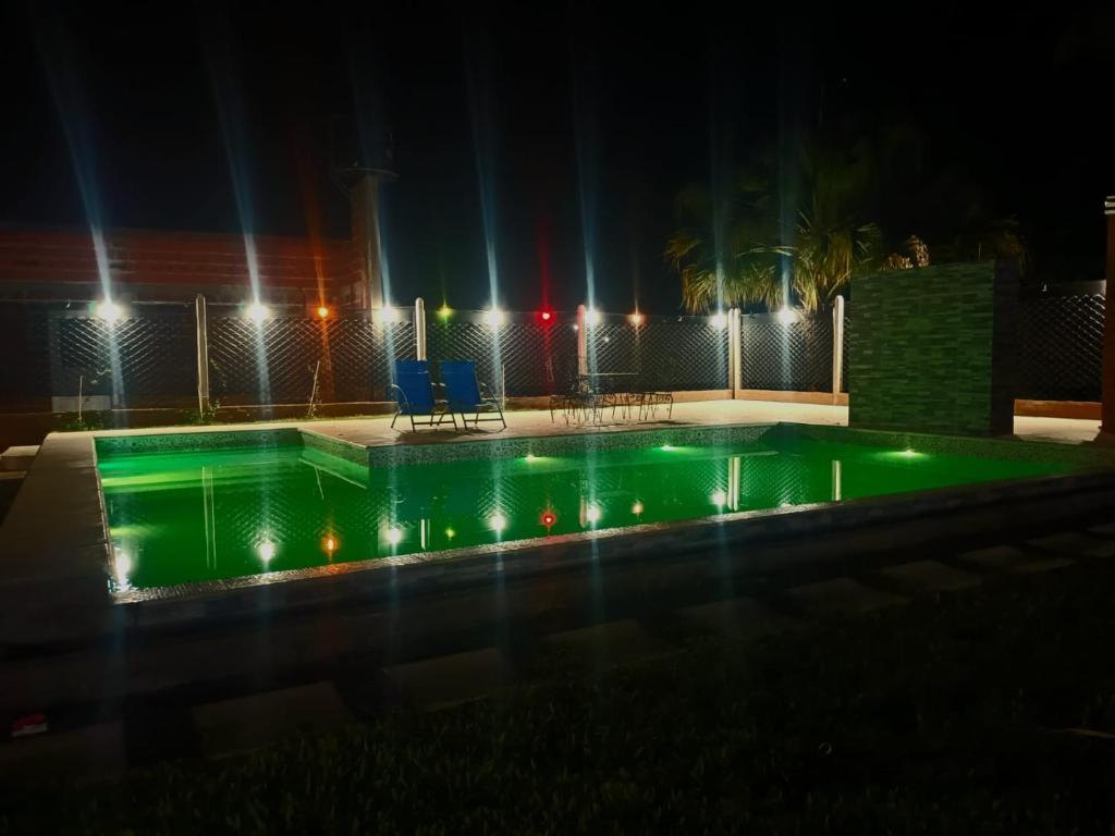 a swimming pool at night with lights at RINCON SOÑADO in Paso de la Patria