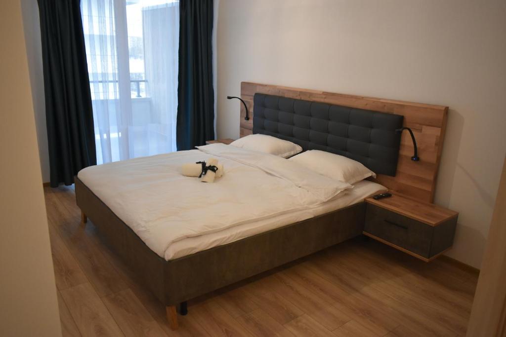 a bed with a cat sitting on top of it at Save Relaxing Residence Brasov in Braşov