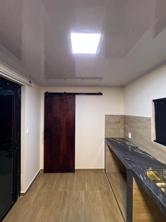 an empty room with a door and a wooden table at Container Home Py in Puerto Presidente Franco